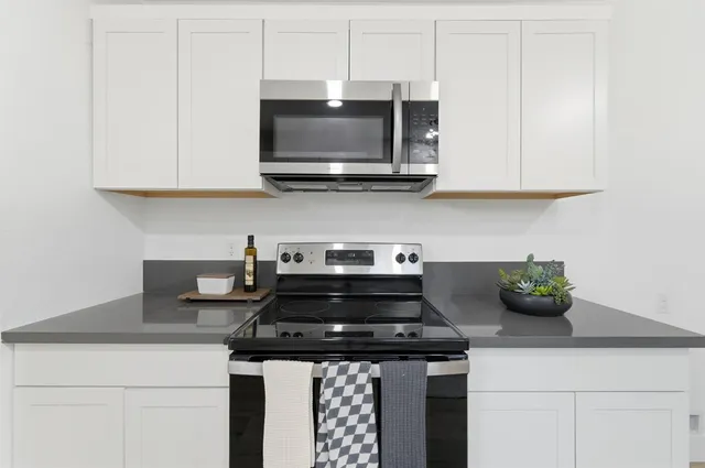 a kitchen with a stove and a microwave