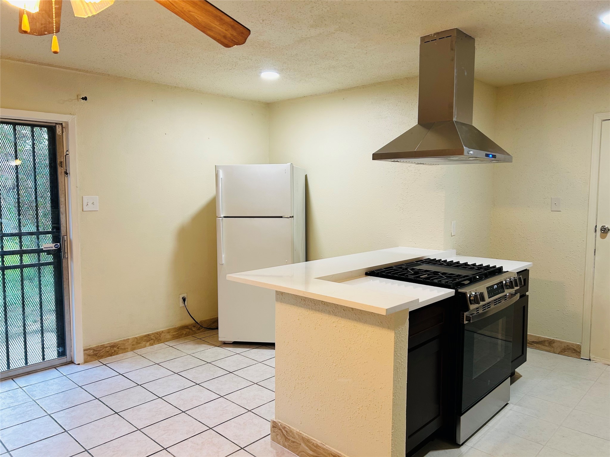 7619 Vernwood Street Houston, TX 77040 - Photo 13 of 25 a kitchen with a stove and a refrigerator