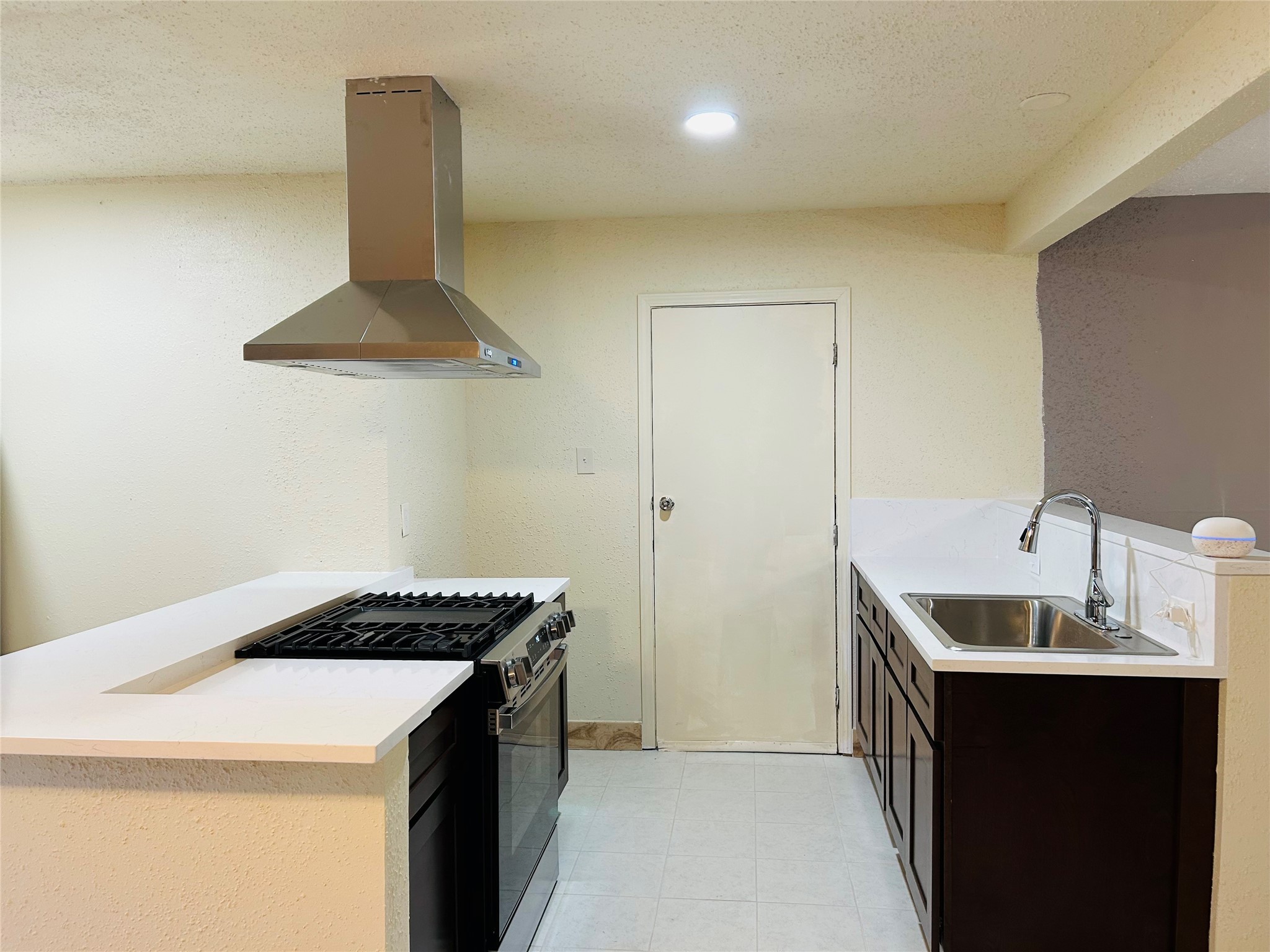 7619 Vernwood Street Houston, TX 77040 - Photo 14 of 25 a kitchen that has a sink and a stove in it