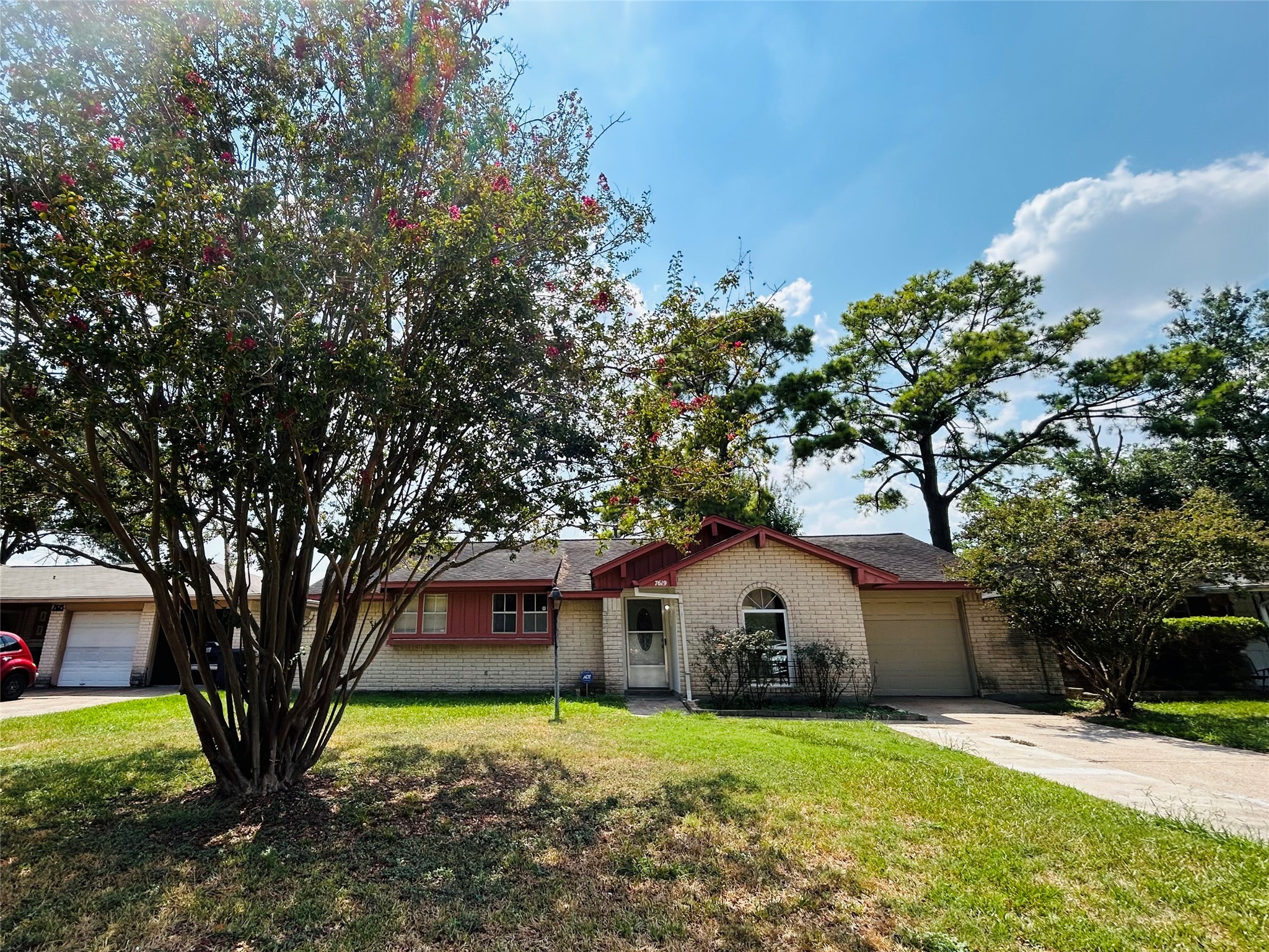 7619 Vernwood Street Houston, TX 77040 - Photo 2 of 25 a front view of a house with a garden and trees