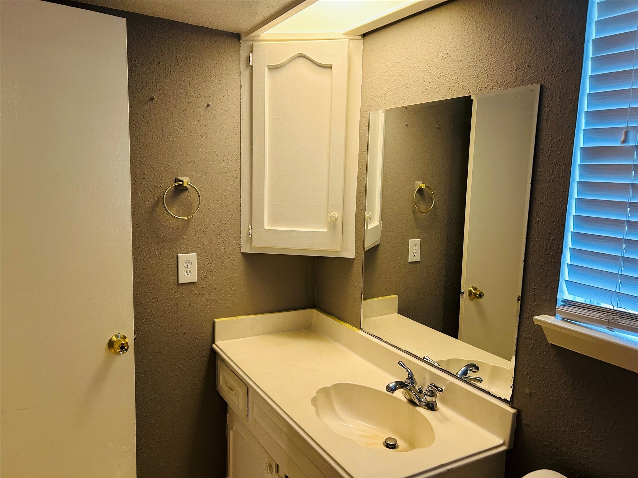 7619 Vernwood Street Houston, TX 77040 - Photo 22 of 25 a bathroom with a sink and a mirror