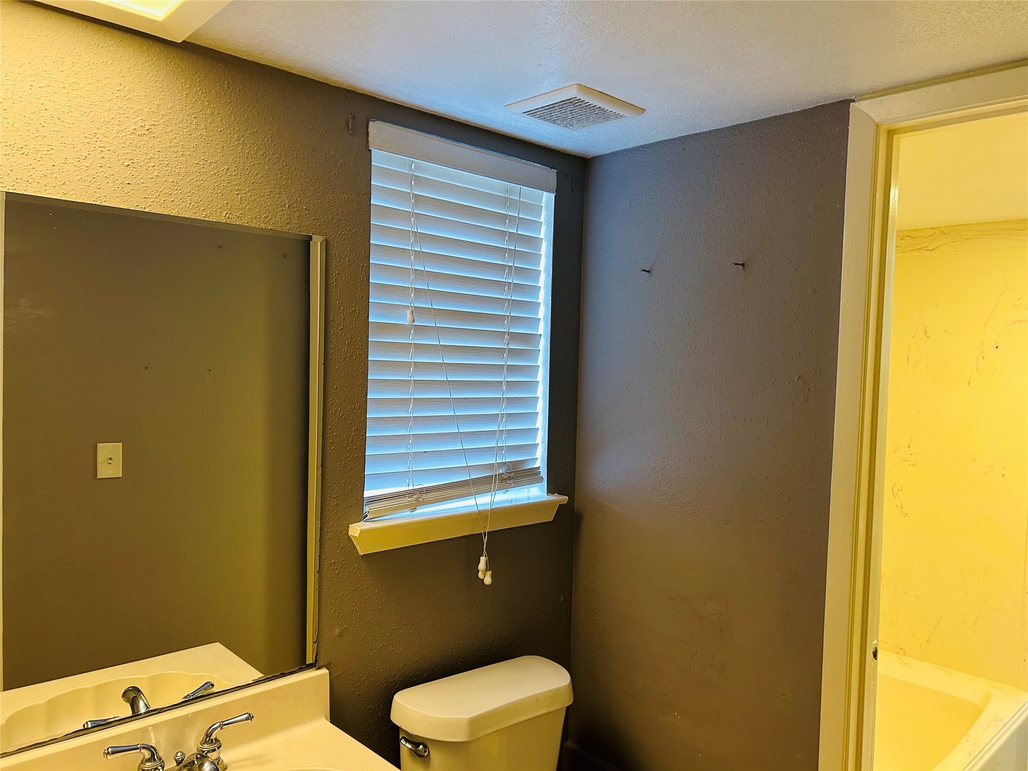 7619 Vernwood Street Houston, TX 77040 - Photo 23 of 25 a bathroom with a toilet sink and a window