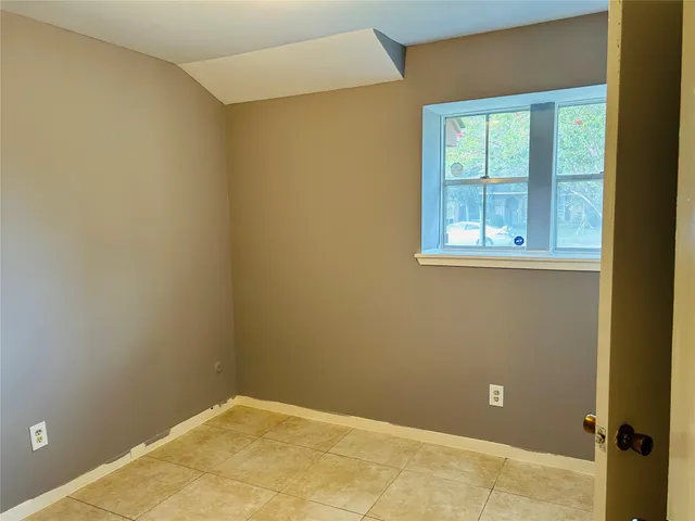 a view of a hallway with wooden door
