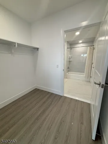 a view of a room with wooden floors and sliding door