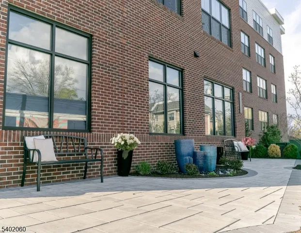 a front view of a brick house with a large windows