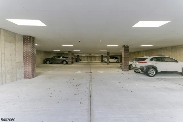 a view of a livingroom with furniture and cars