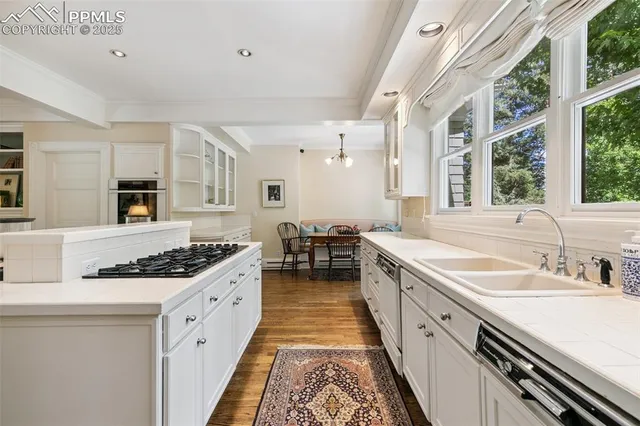a kitchen with stainless steel appliances granite countertop a sink stove and cabinets