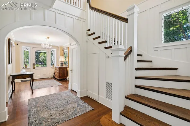 a view of entryway and hall with wooden floor