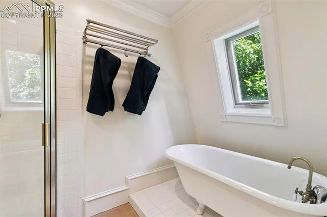 a bathroom with a bathtub and a window