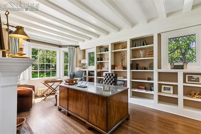 a dining room with furniture and a floor to ceiling window