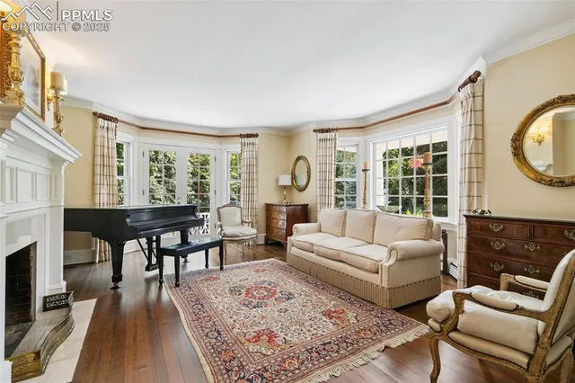 a living room with furniture a fireplace and wooden floor