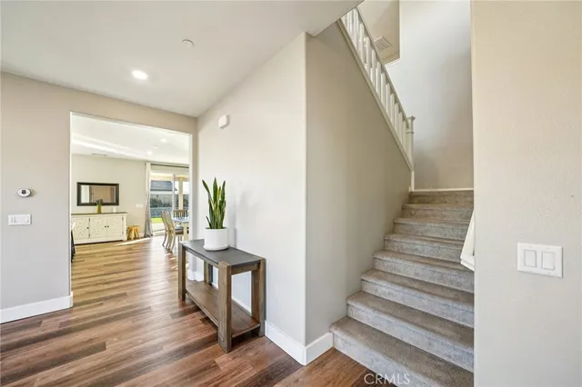 a view of entryway and hall with wooden floor