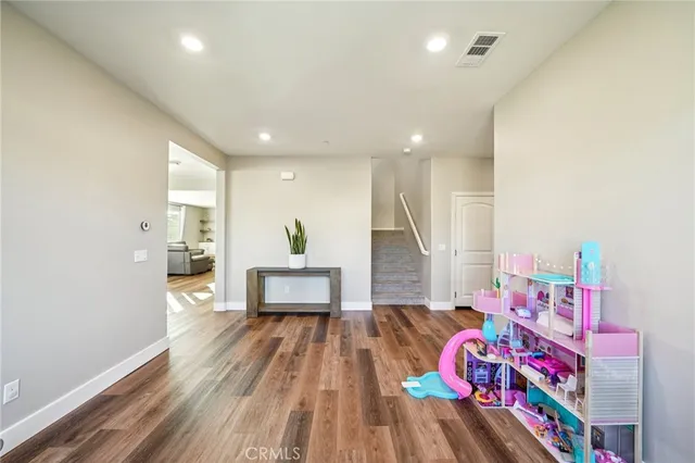a bedroom with furniture and a wooden floor