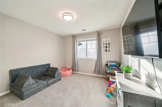 a bedroom with a bed couch and window