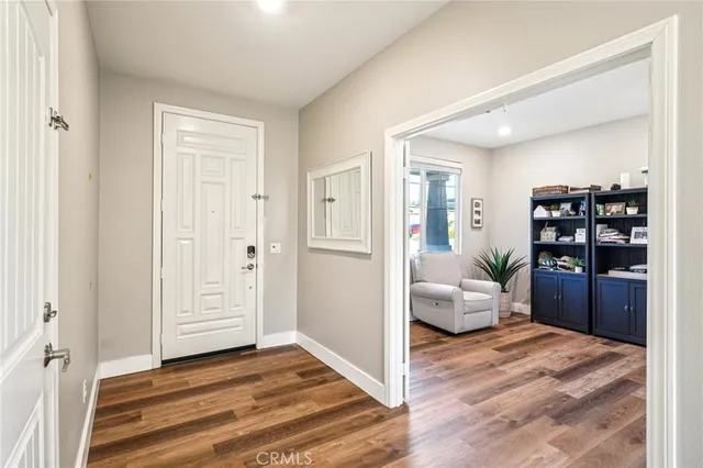 a view of a bedroom with wooden floor and bedroom space