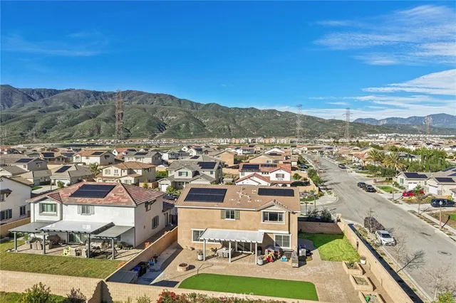 a view of a patio with a table and chairs under an umbrella