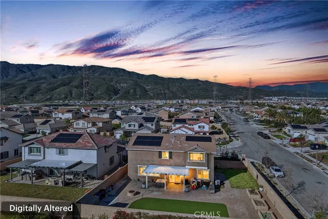 a patio with a table and chairs under an umbrella