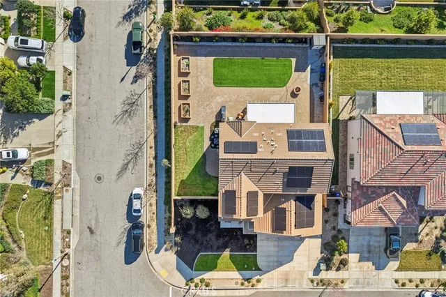 a view of a patio with chairs and a flower garden