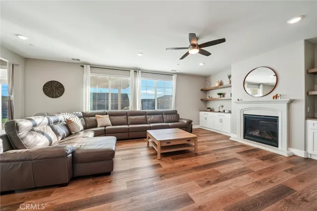 a living room with furniture a fireplace and a large window