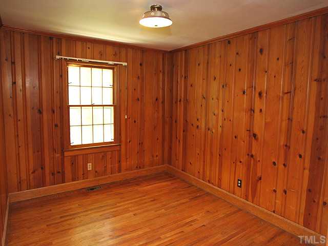 2452 Oxford Road Raleigh, NC 27608 - Photo 12 of 25 a view of an empty room with wooden floor and a window
