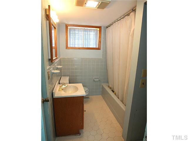 2452 Oxford Road Raleigh, NC 27608 - Photo 17 of 25 a bathroom with a sink and a mirror