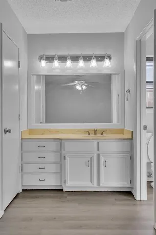 a view of granite countertop cabinets and a wooden floor