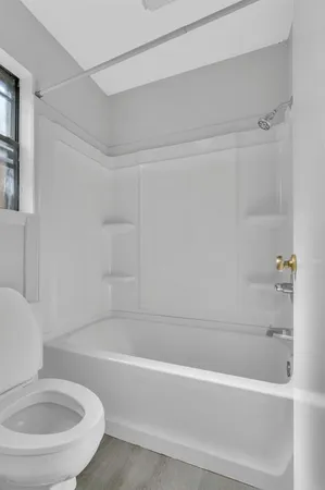 a bathroom with a bathtub and a toilet