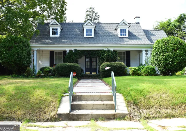 a front view of a house with garden