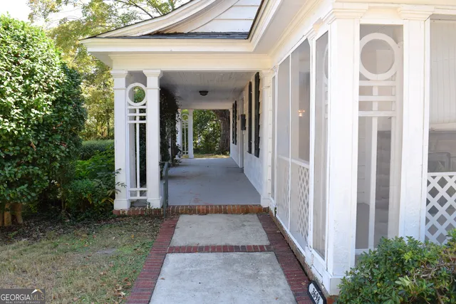a view of a pathway of a house with potted plants