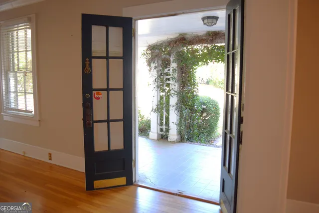 a view of a floor to ceiling window and wooden floor