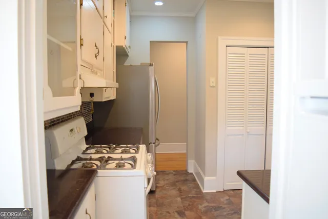 a kitchen with a refrigerator and a stove