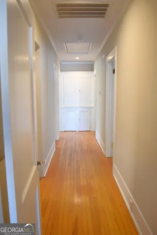 a view of a hallway with wooden floor