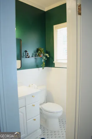 a bathroom with a sink a toilet and mirror