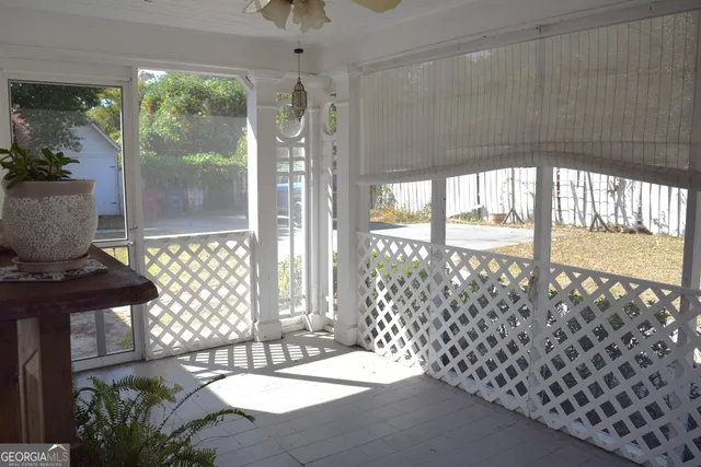 a living room filled with furniture and a floor to ceiling window