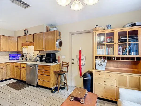 a kitchen with granite countertop a white stove top oven and sink