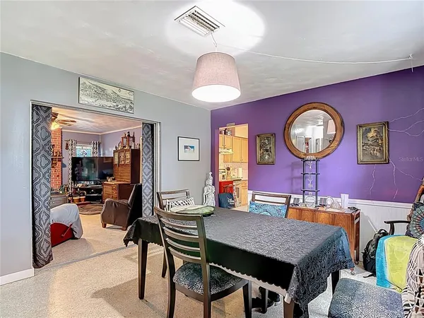 a kitchen with stainless steel appliances granite countertop a stove a sink and a dining table
