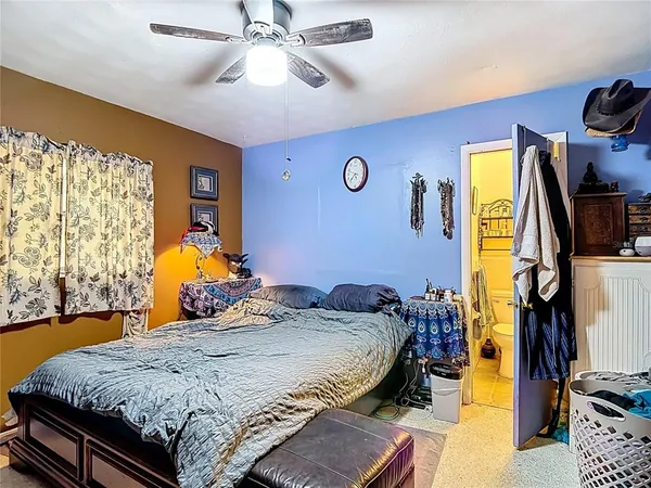 a living room with furniture flat screen tv and wooden floor