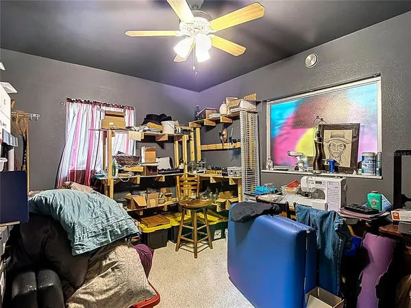 a bed sitting in a bedroom next to a window