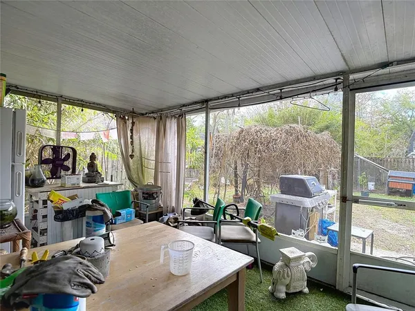 a view of a house with backyard and a tree