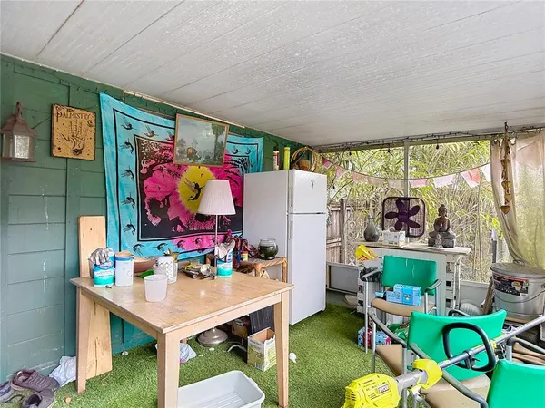 a backyard of a house with table and chairs