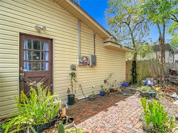 a view of a house with furniture and a yard