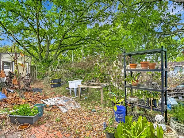 an aerial view of a house with a yard swimming pool outdoor seating and yard