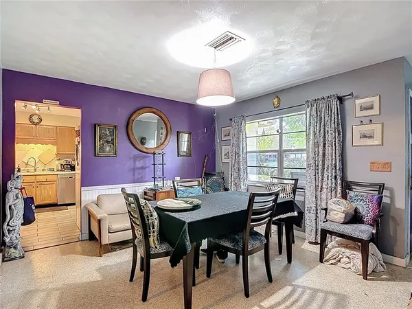 a kitchen with kitchen island granite countertop a sink window and cabinets