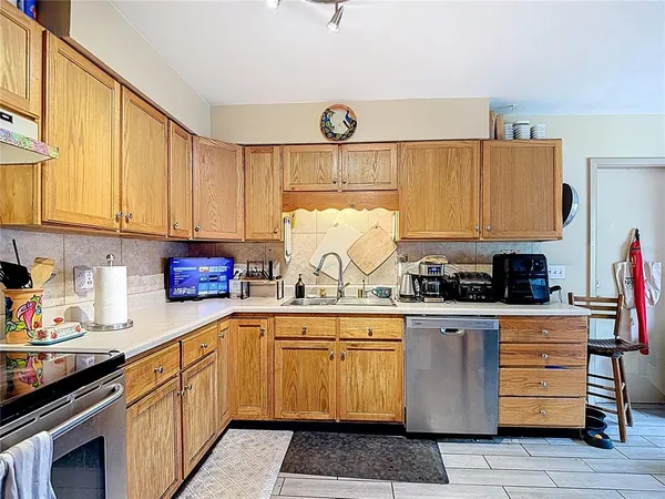 a kitchen with stainless steel appliances granite countertop a refrigerator and stove top oven