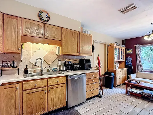 a kitchen with stainless steel appliances granite countertop a sink and cabinets