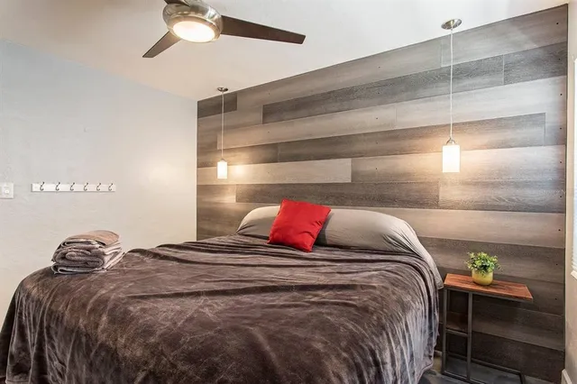 a bed sitting in a bedroom next to a window