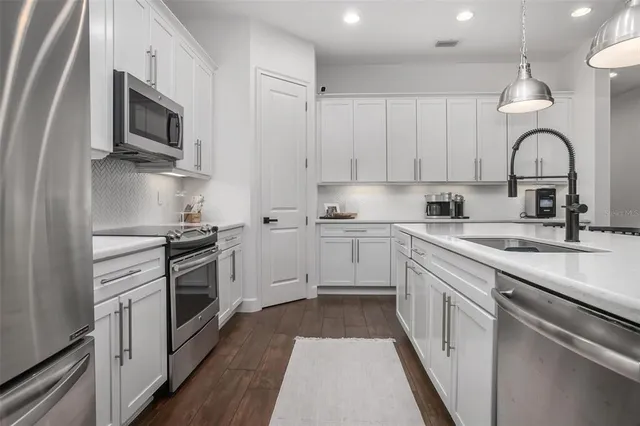 a kitchen with a sink stove and microwave