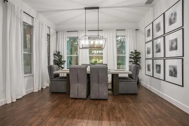 a view of a livingroom with furniture wooden floor and windows