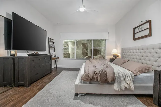 a spacious bedroom with a large bed and a flat screen tv