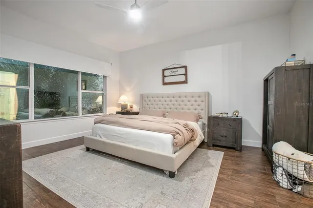 a spacious bedroom with a bed and a large window